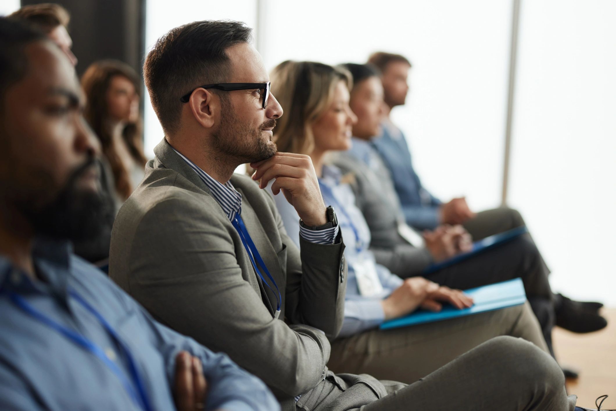 Professionals attending a leadership seminar in a board room