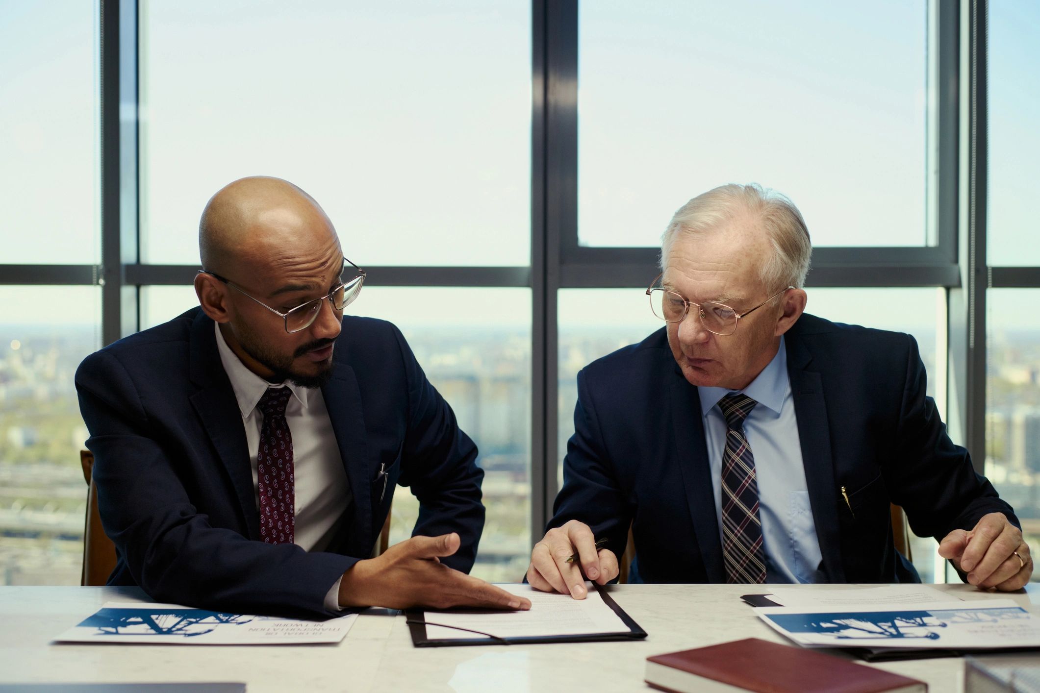 Executives in discussion reviewing strategic documents
